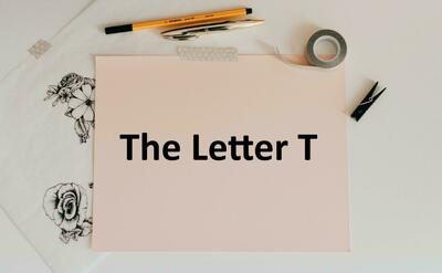 Letter T written on a paper.