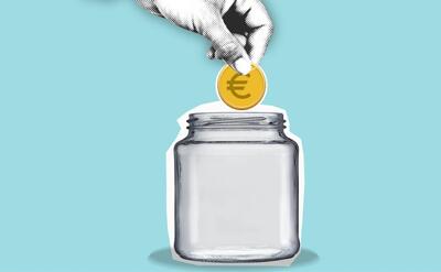 Hand tossing the coin into jar