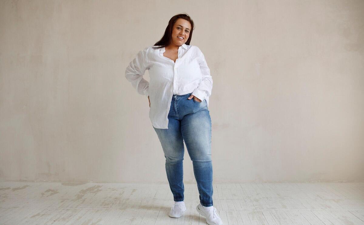 Full shot plus size model posing in studio