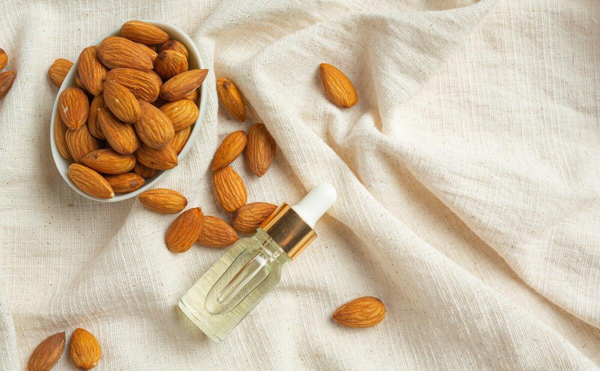 Body almond moisturizer on white background