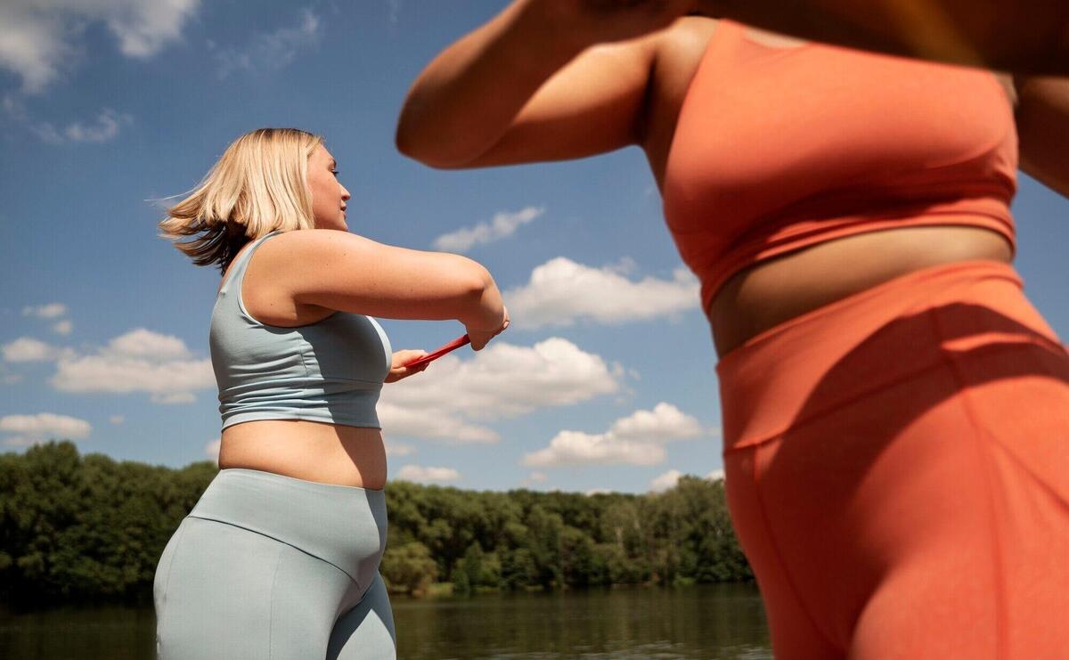 Side view women exercising together