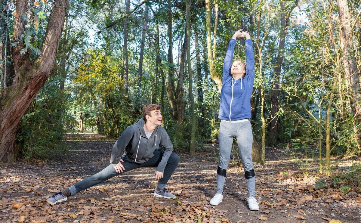 Friends in sportswear doing stretches on a sunny day