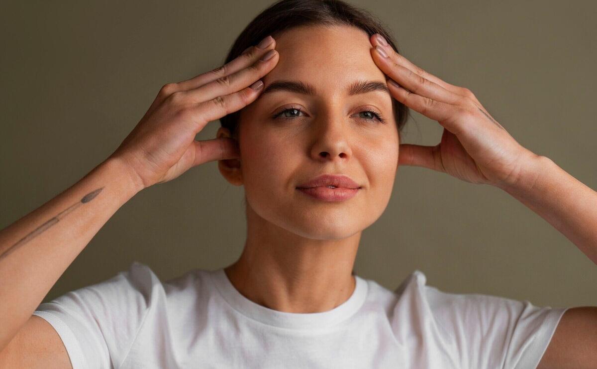 Portrait of young woman practicing facial yoga for youth