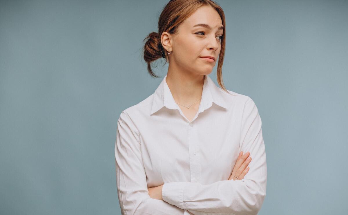 Woman in white shirt showing emotions on blue