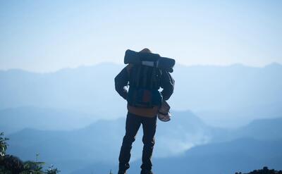 Man Traveler with backpack mountaineering Travel Lifestyle concept