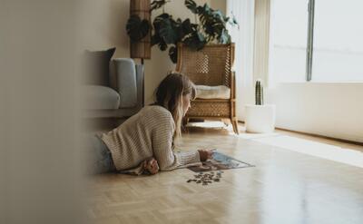 Woman putting together a jigsaw puzzle during self quarantine