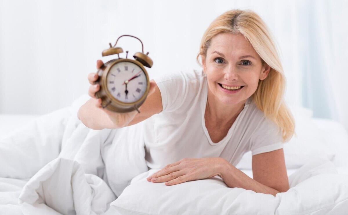 Beautiful senior woman holding a clock