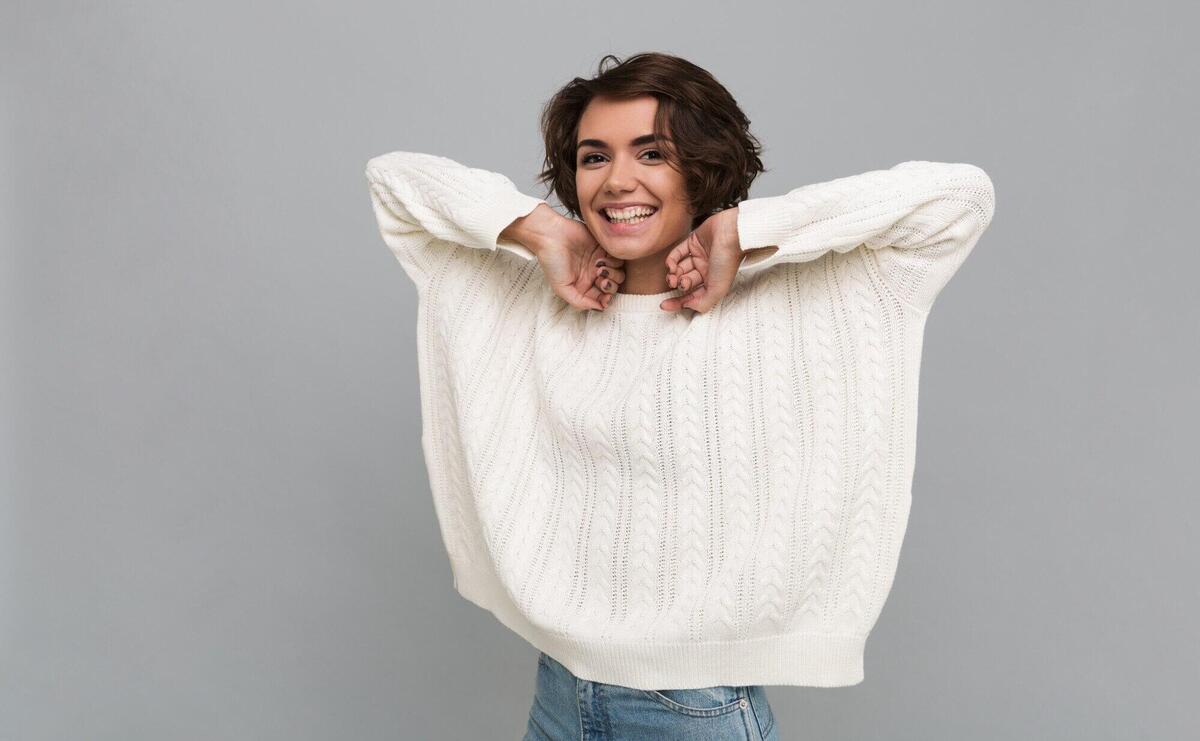 Portrait of a pretty casual woman in sweater laughing