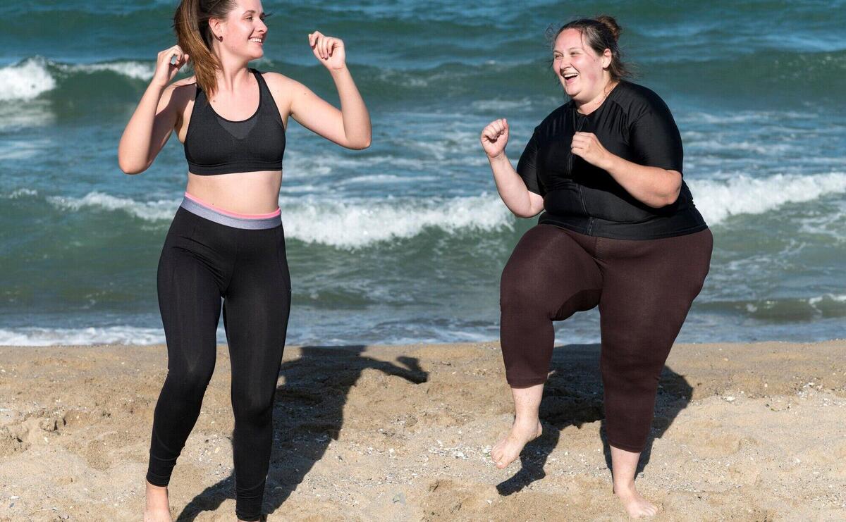 Happy women training together full shot