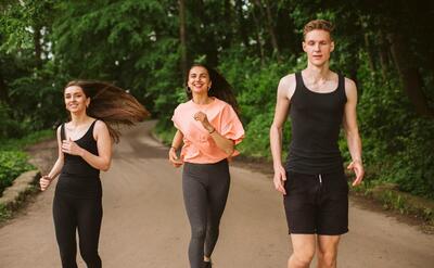 Front view friends running in nature