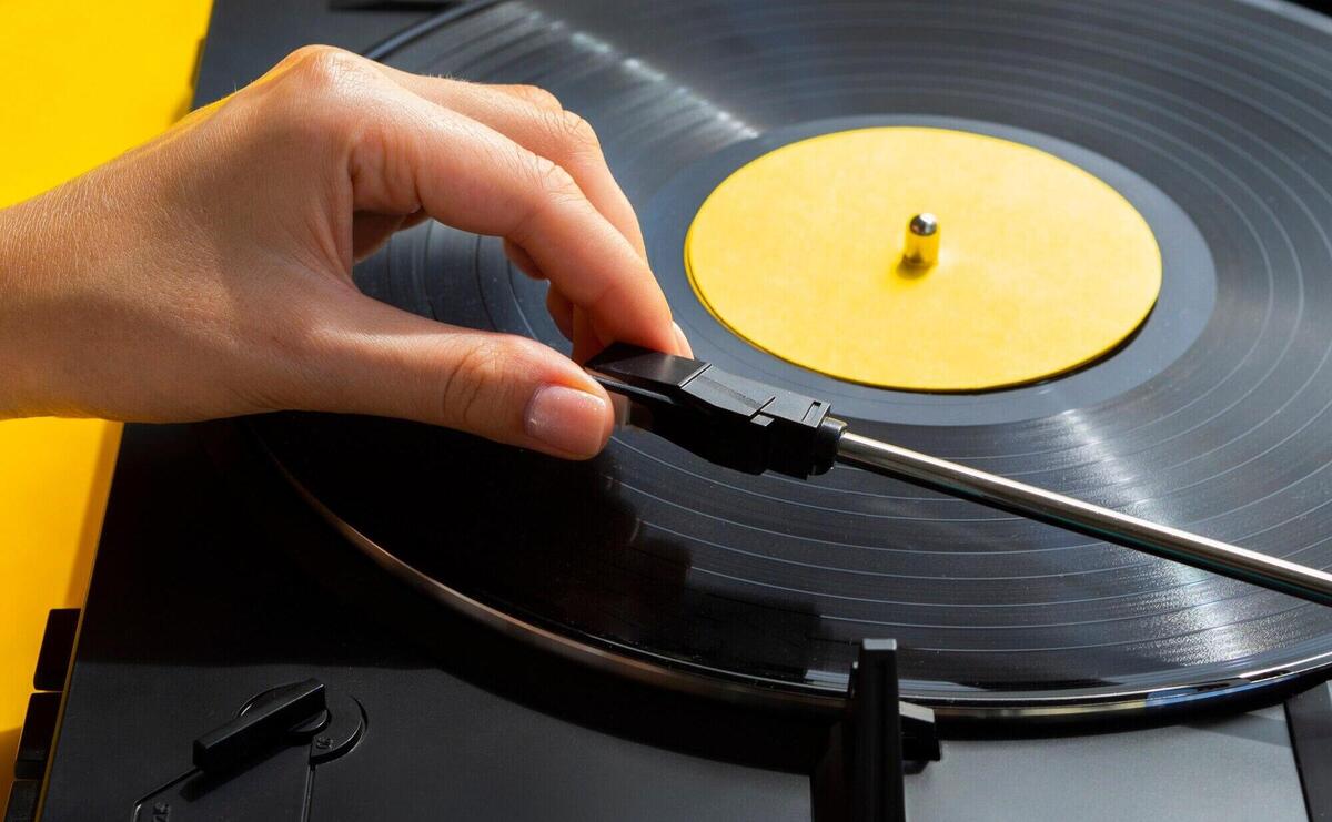 Person placing vinyl record in player