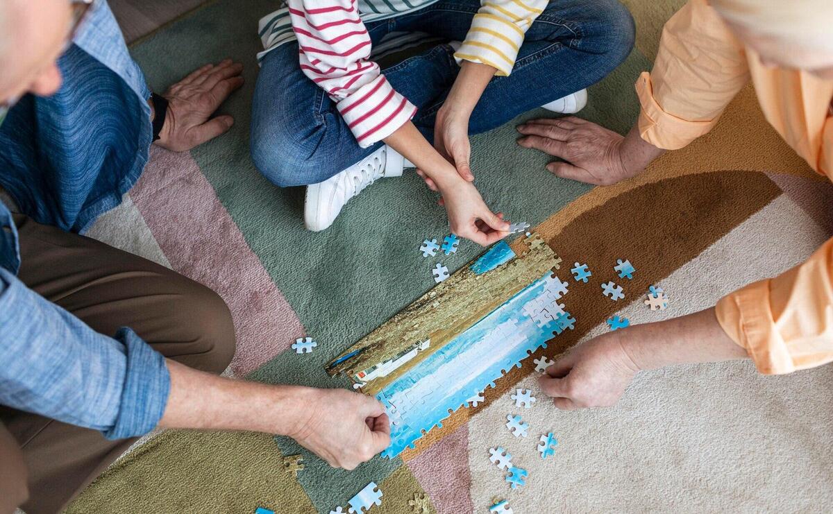 People doing puzzle on floor close up