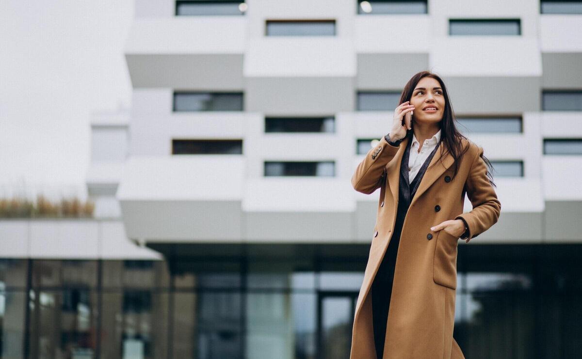 Young business woman using phone