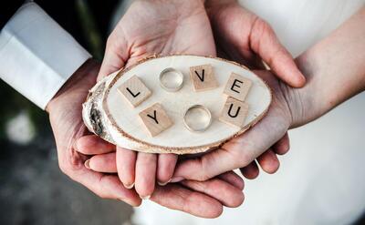 Top view of couple holding the wedding rings