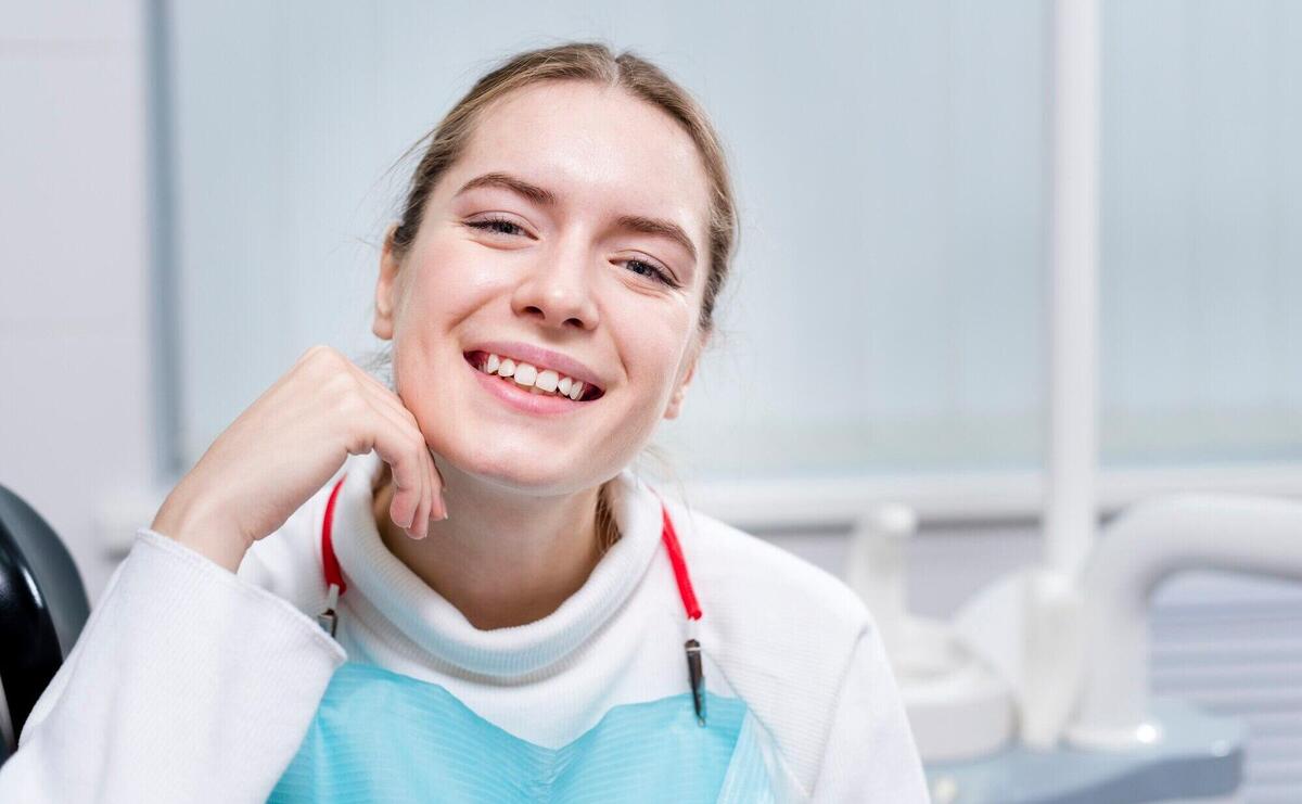 Portrait of smiley adult woman at the dentist