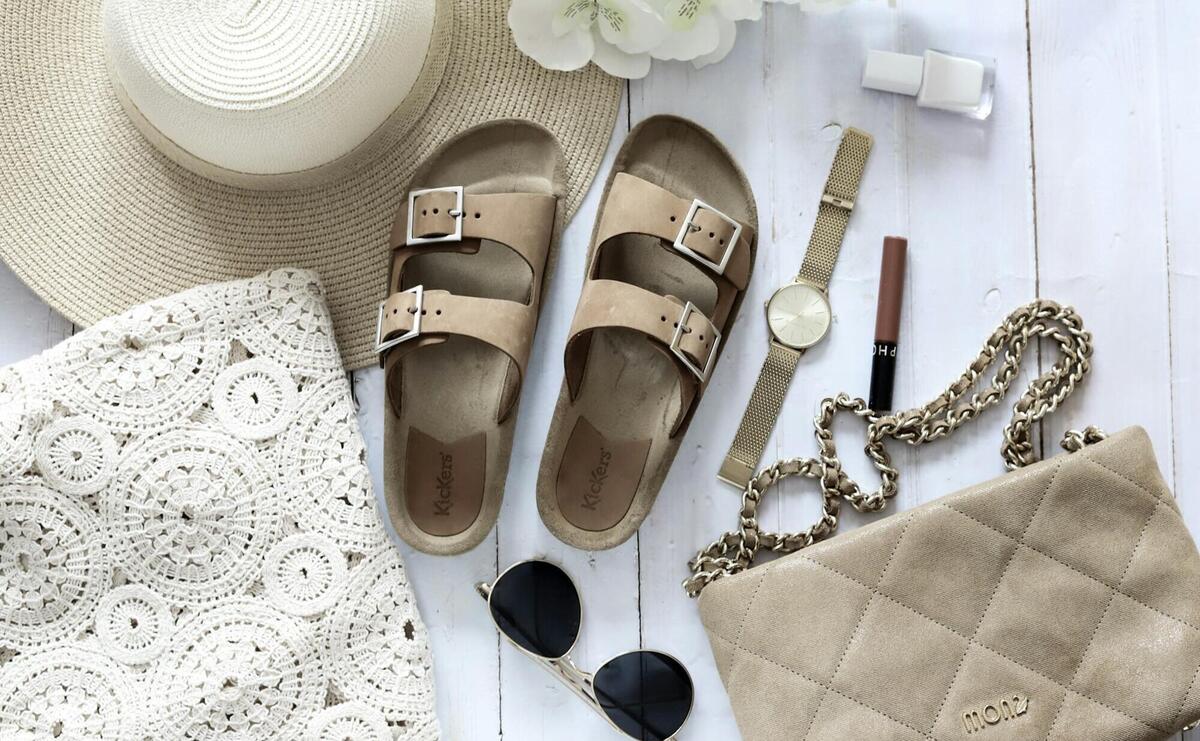 brown leather sandals beside black sunglasses
