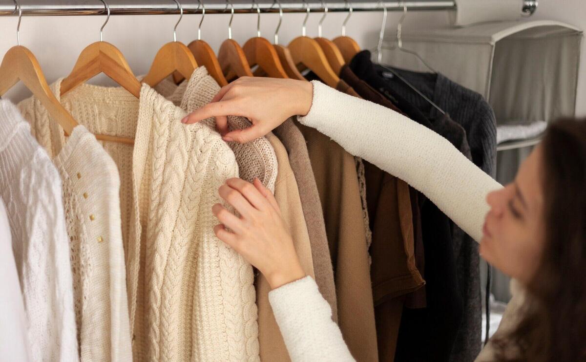 Close up woman arranging wardrobe