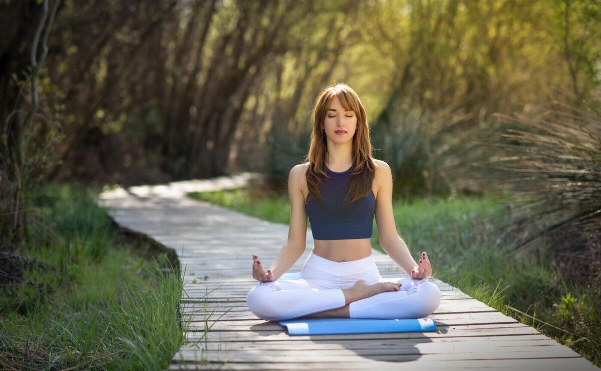 Young beautiful woman doing yoga in nature