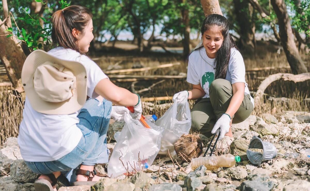 Group of asian diverse people volunteer teamwork environment conservationvolunteer help to picking plastic and foam garbage on park areaVolunteering world environment day