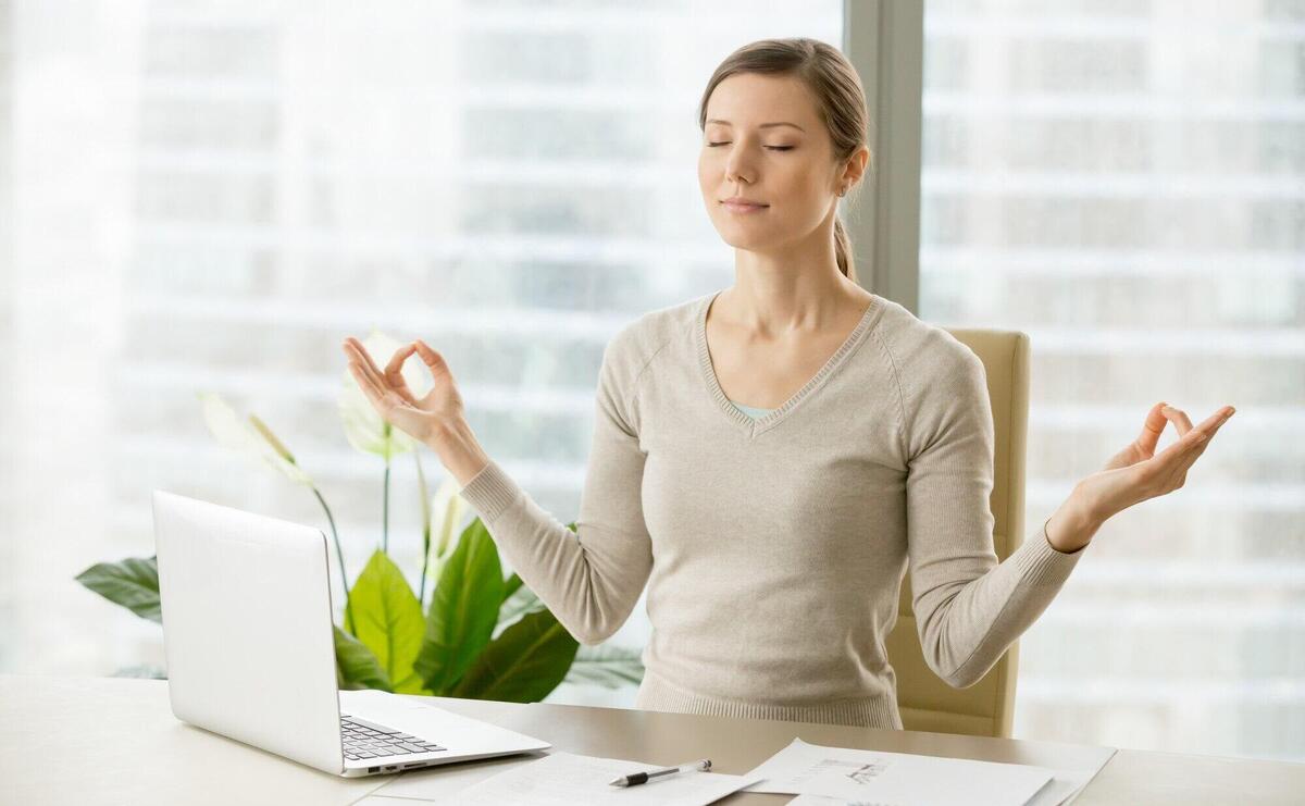 Calm businesswoman relaxing with breath gymnastics