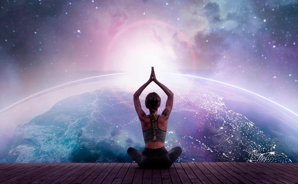 Back view woman meditating in space