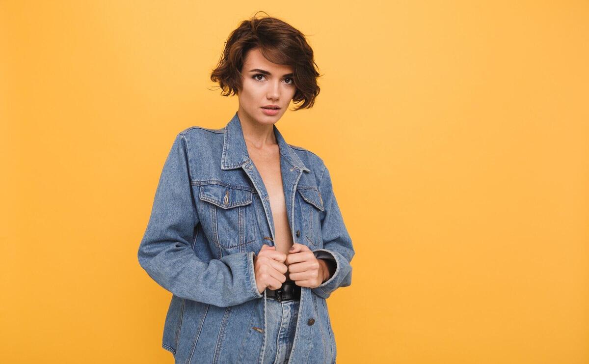 Portrait of a beautiful brunette woman dressed in denim jacket