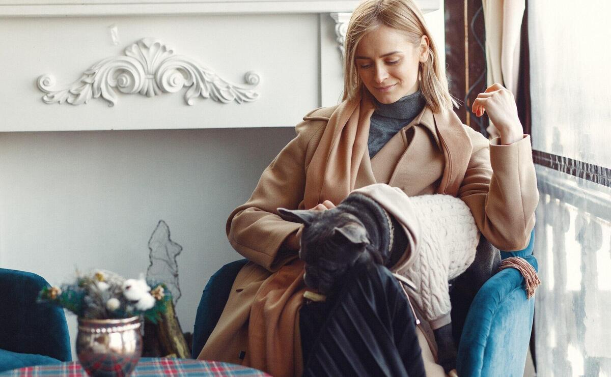 Elegant woman in a brown coat with black bulldog