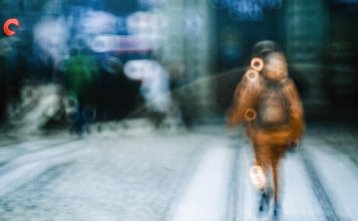 Blurred picture of person walking along the street 