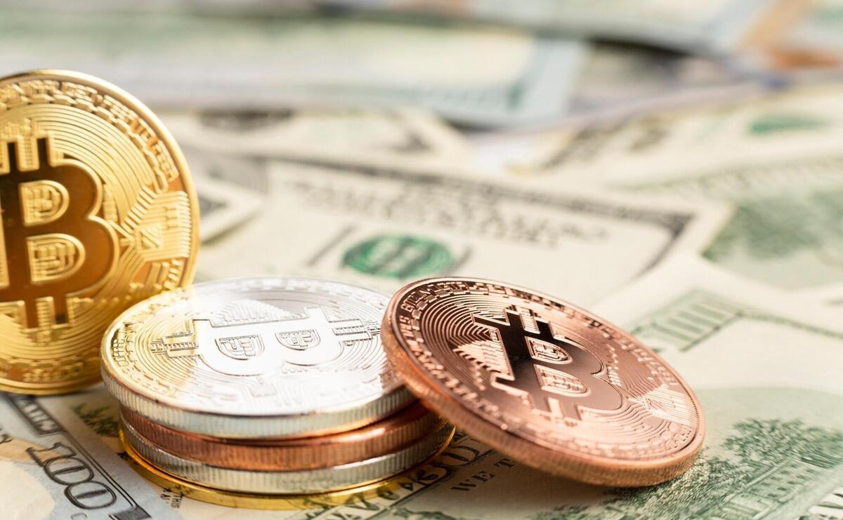 Bitcoin pile on top of dolar bills