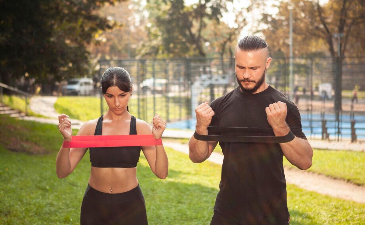 Rubber band hands exercise with sportive friends