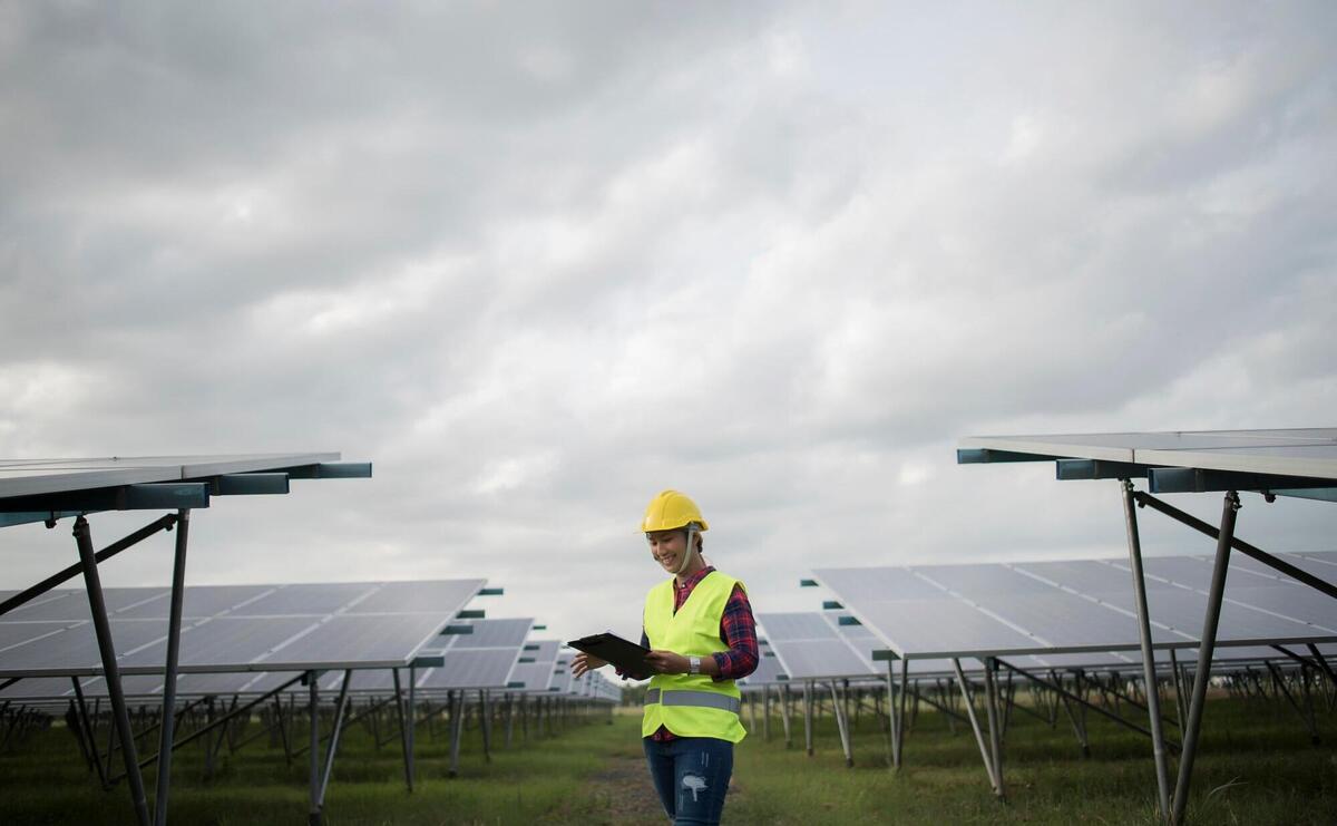 Engineer electric woman checking and maintenance of solar cells.