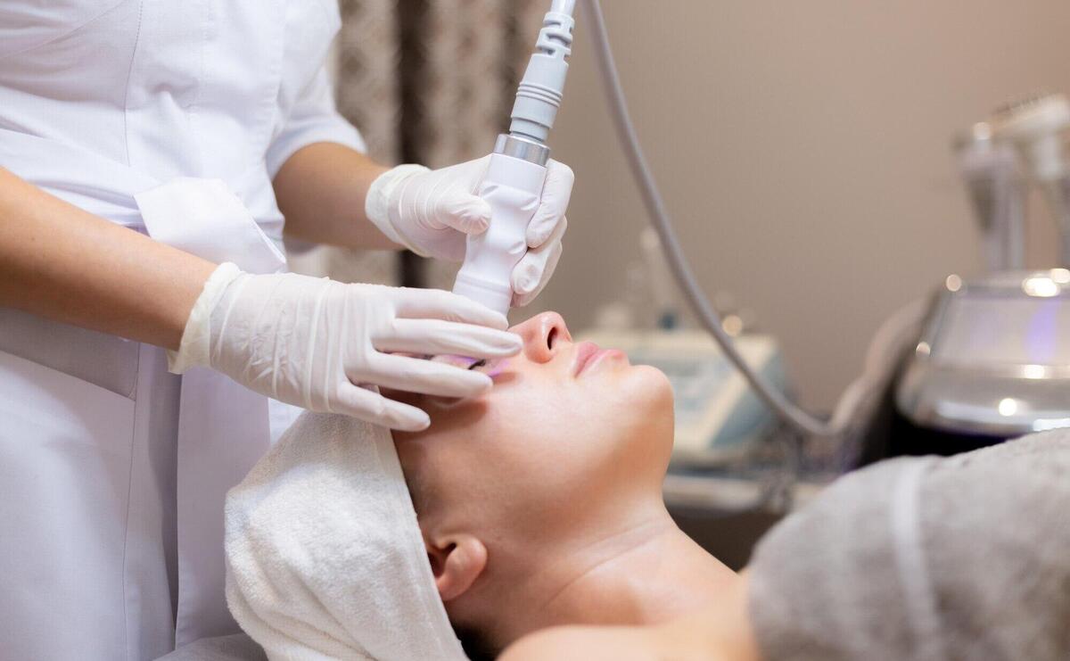 A young beautiful girl lies on the beautician's table and receives procedures