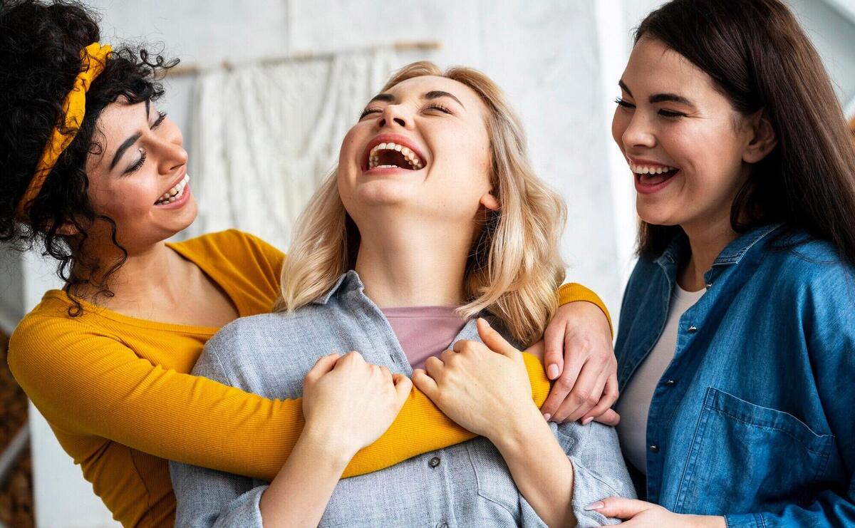 Three embraced women laughing together