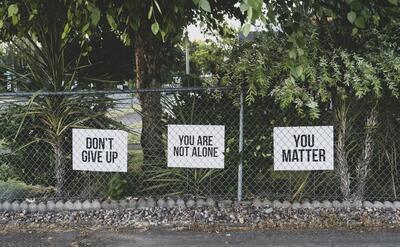 don't give up. You are not alone, you matter signage on metal fence