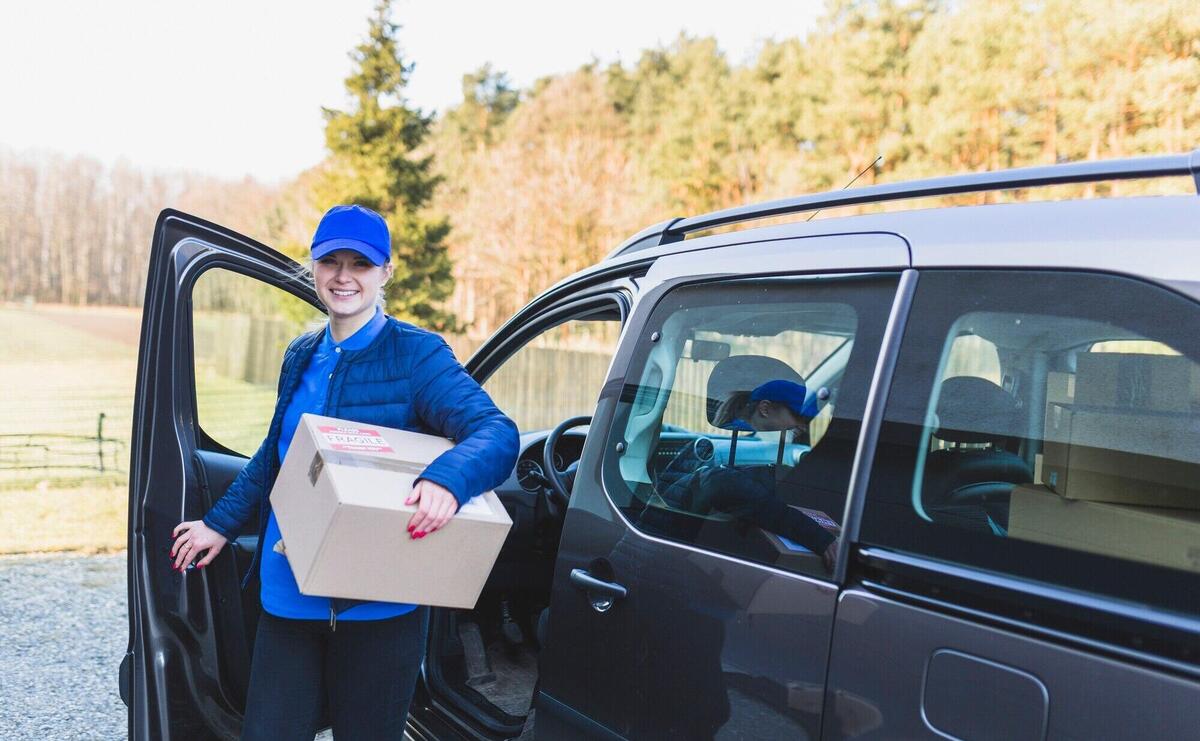 Girl with box working in delivery service