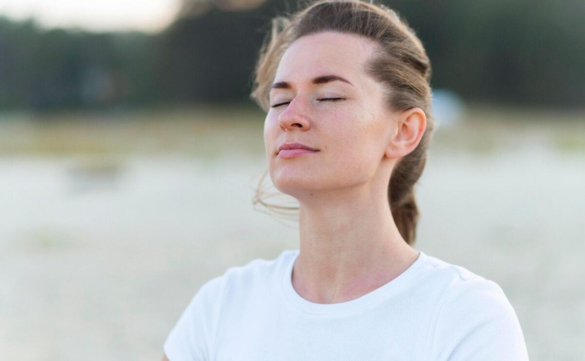 Woman taking in the fresh ocean breeze on the beach during workout