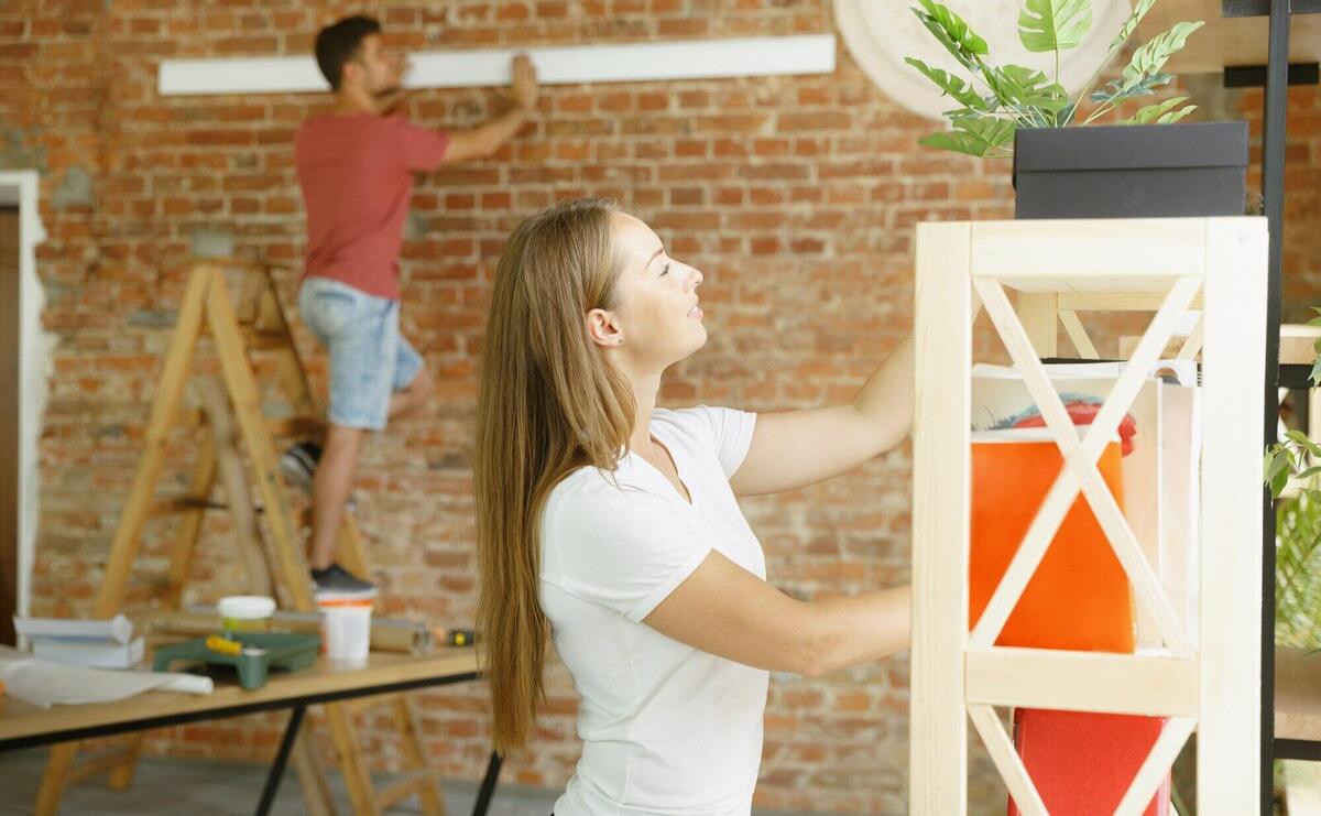 Young couple doing apartment repair together themselves.