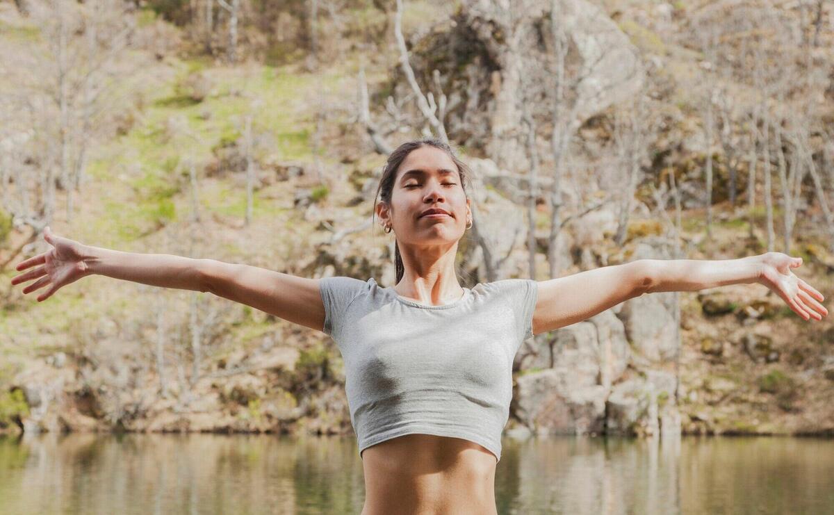  teenager stretching his arms with closed eyes