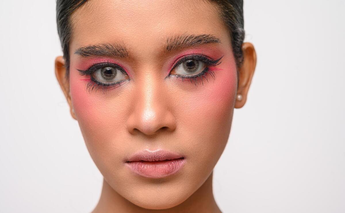 The girl had beautiful pink makeup isolated on white