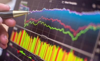 Stock exchange monitor screen closeup on tablet with businessman finger analysis