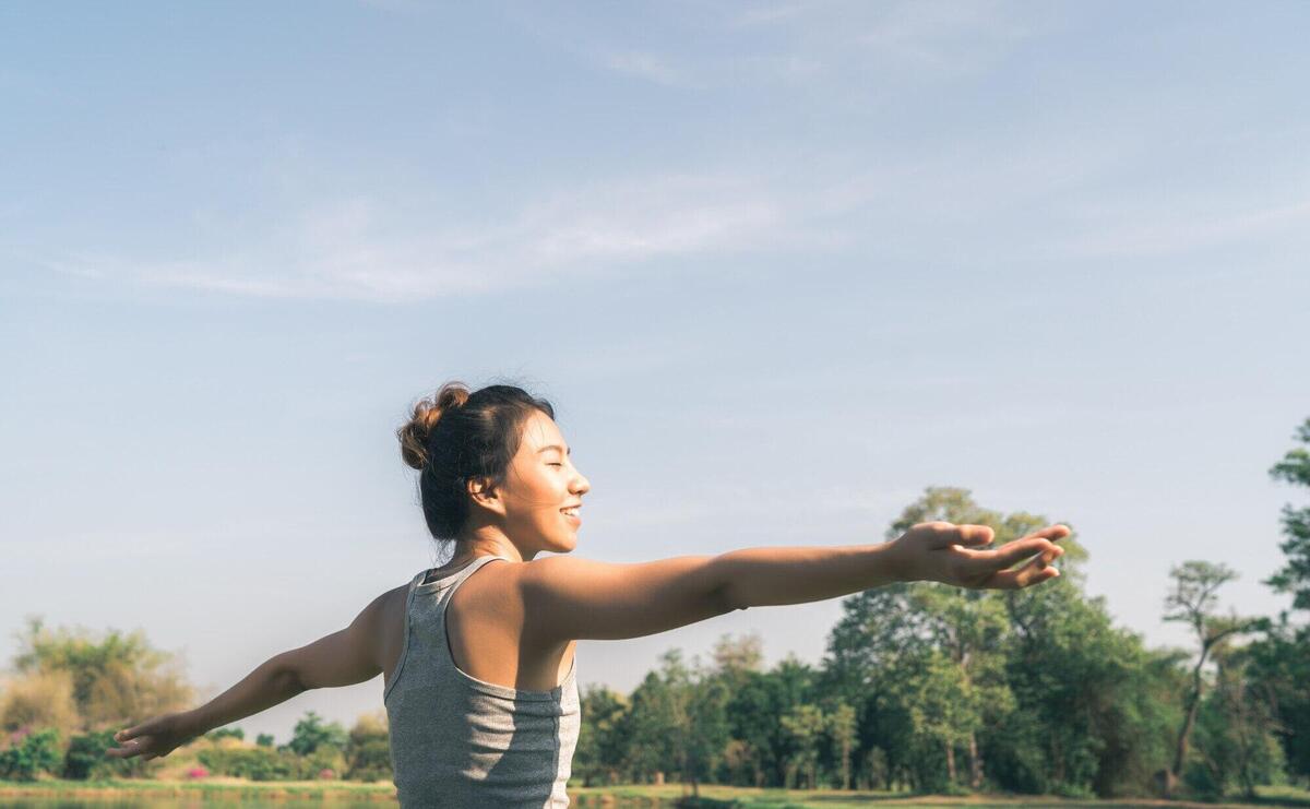 Young asian woman yoga outdoors keep calm and meditates while practicing yoga