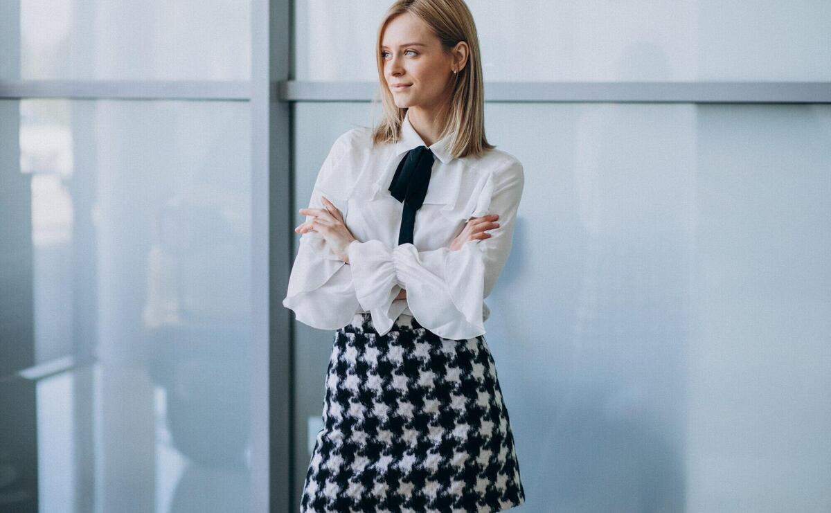 Young pretty business woman standing in office